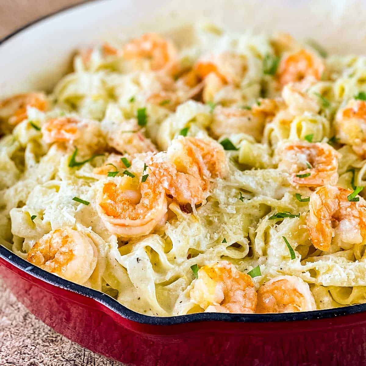 Olive Garden shrimp Alfredo copycat recipe with creamy fettuccine, shrimp, Parmesan cheese, and parsley.