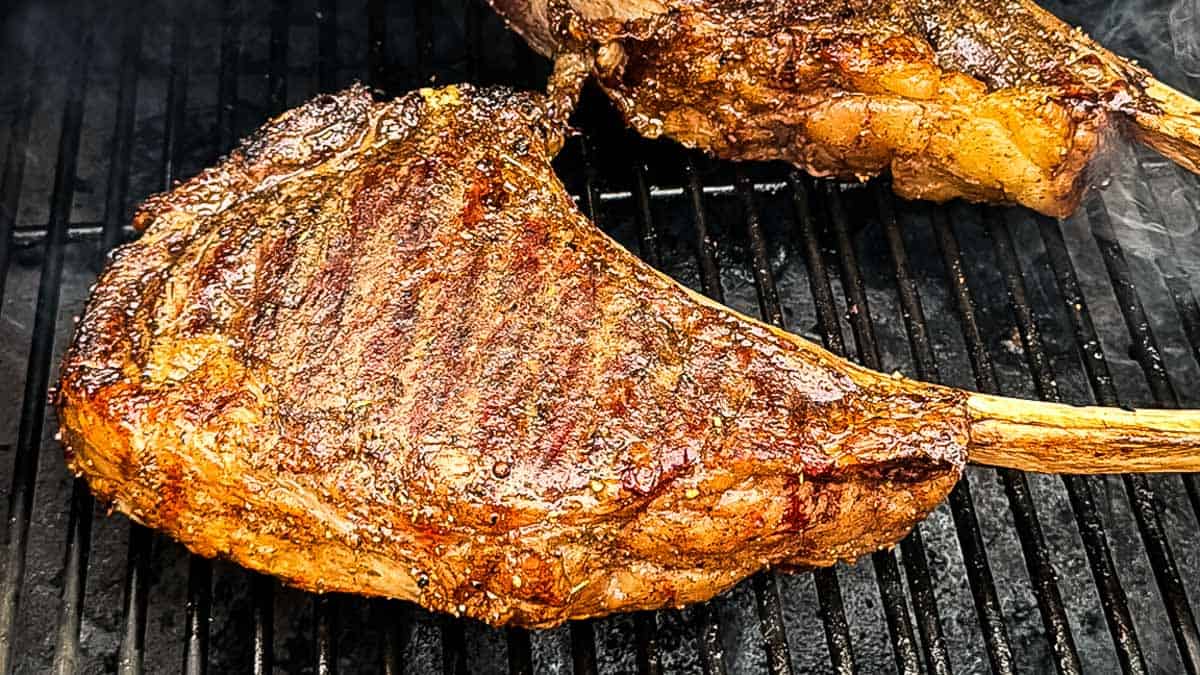 Smoked tomahawk steaks on a pellet grill with a browned crust after the reverse sear.