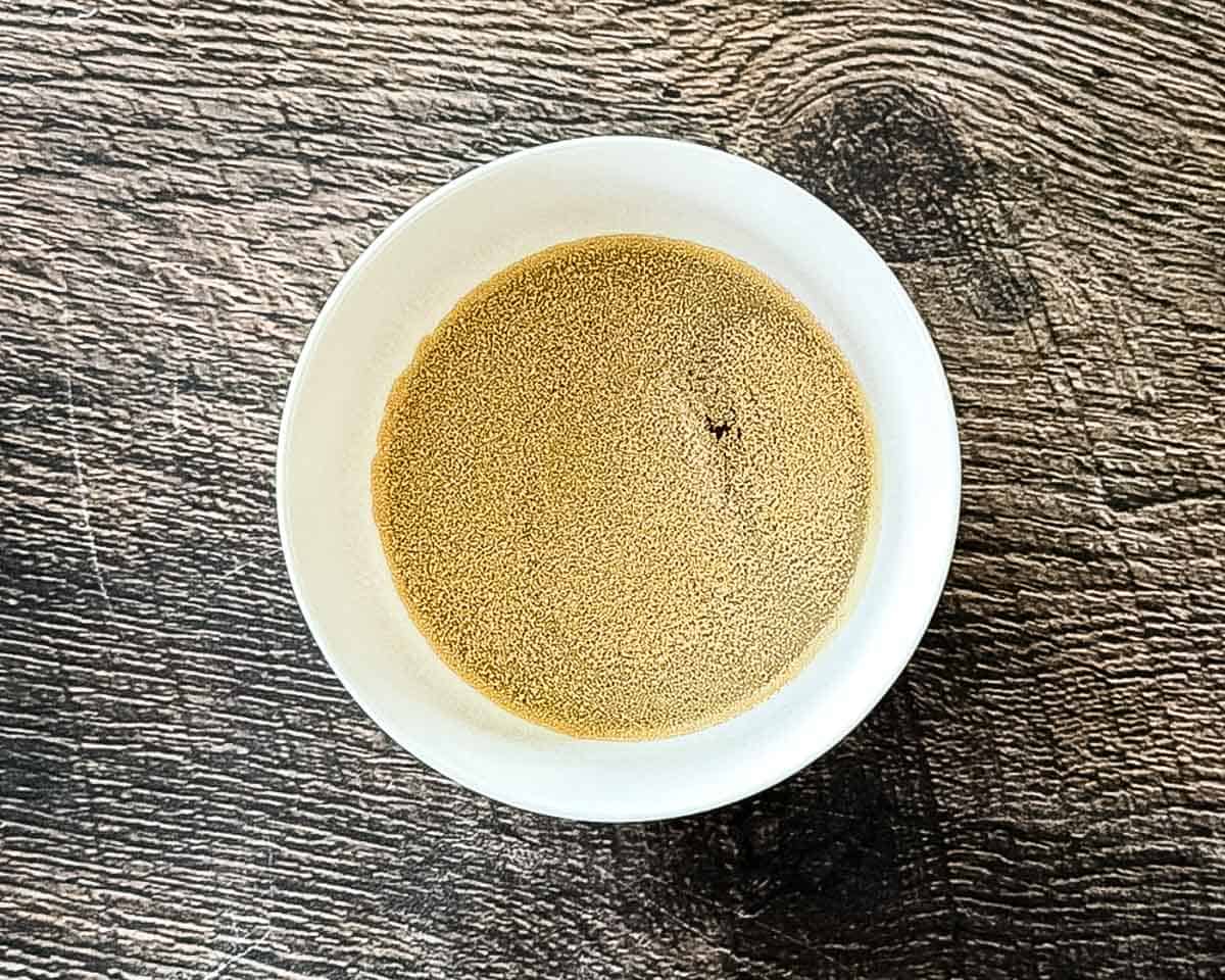 Active dry yeast sprinkled over warm water and sugar.