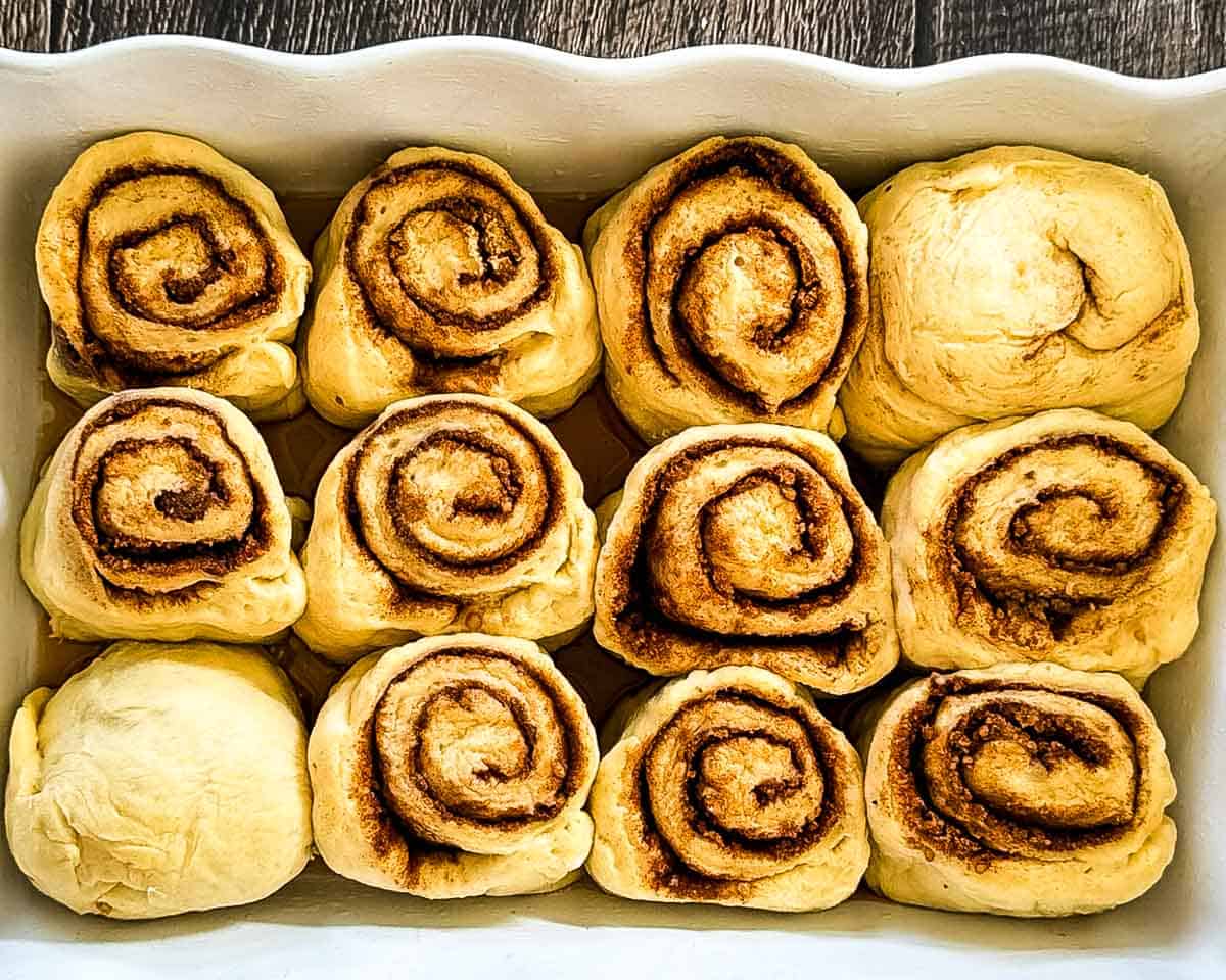 Cinnamon buns in a baking dish after the second rise.