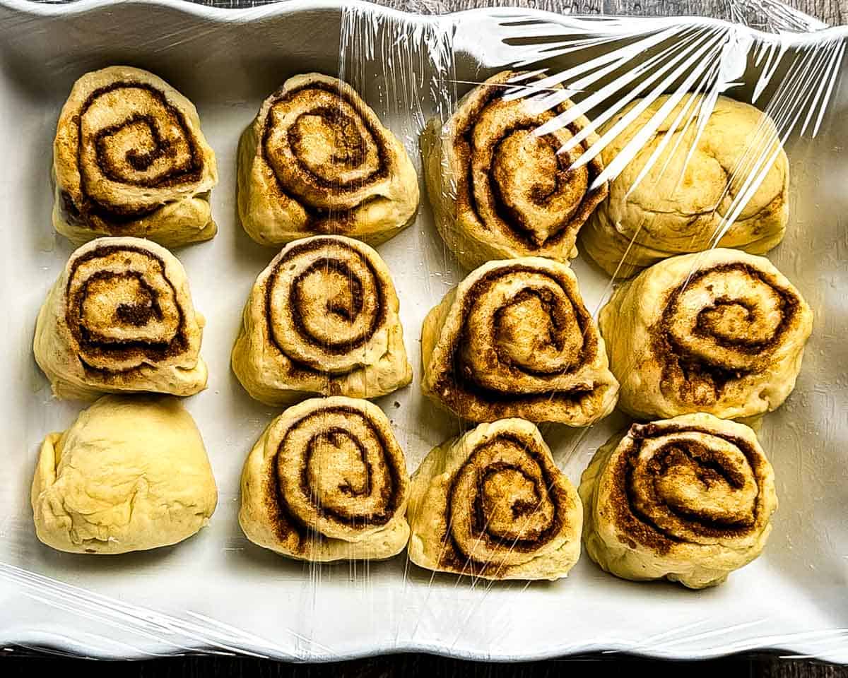 Cinnamon buns in a baking dish for the second rise.