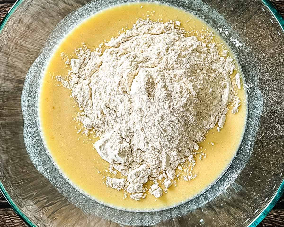 Flour added to the wet ingredients for cinnamon bun dough.