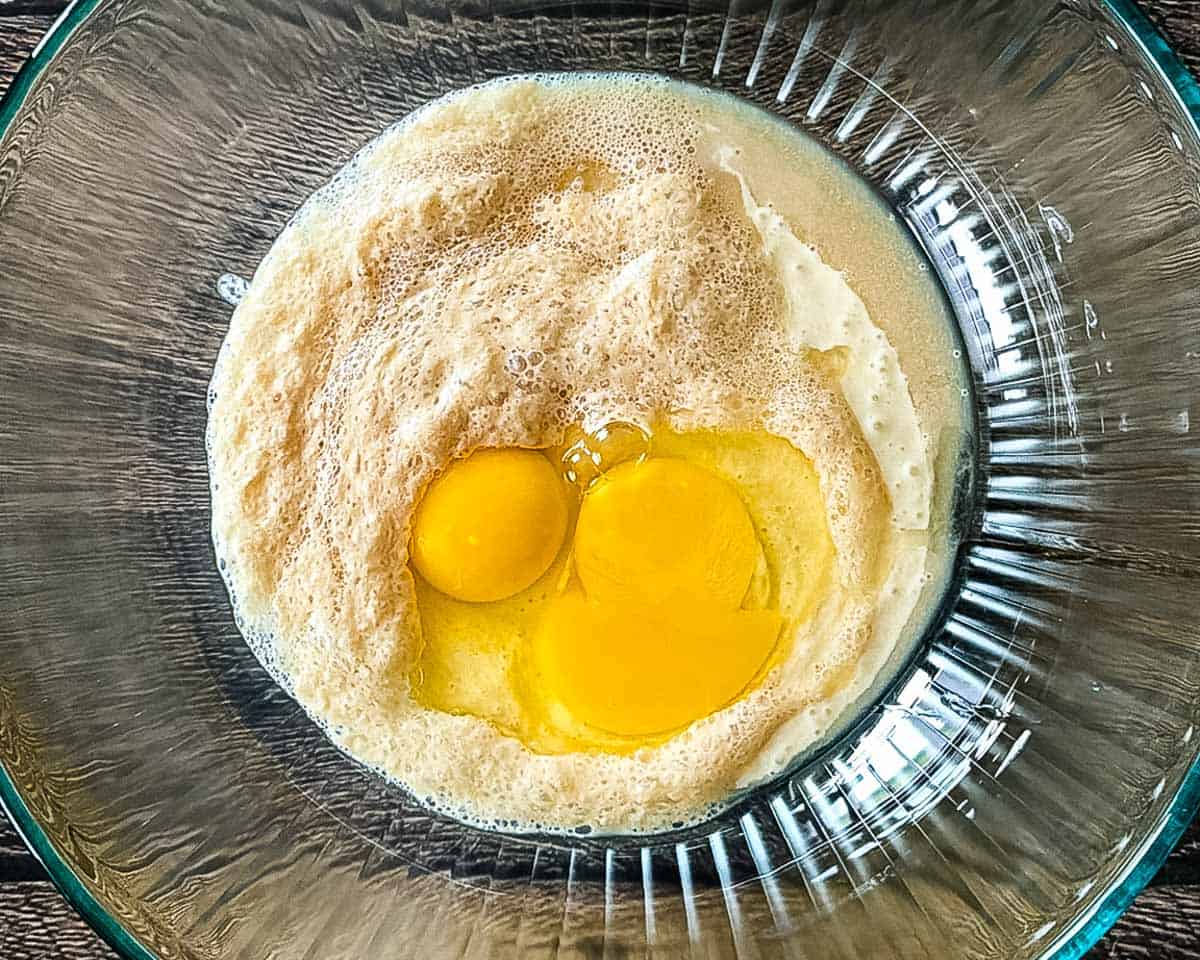 Eggs added to the wet ingredients for sourdough discard cinnamon bun dough.