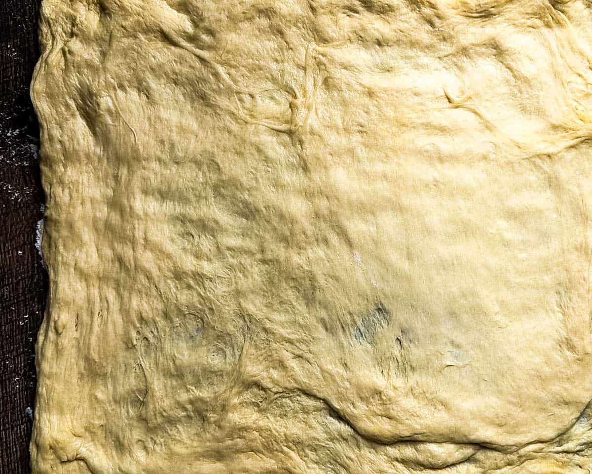 Cinnamon bun dough pulled into a rectangle.