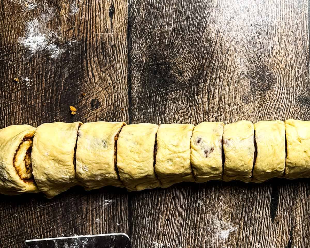 Cinnamon bun dough cut into individual rolls.