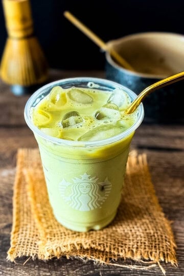 Starbucks iced matcha latte with milk, matcha, ice, and a gold straw.