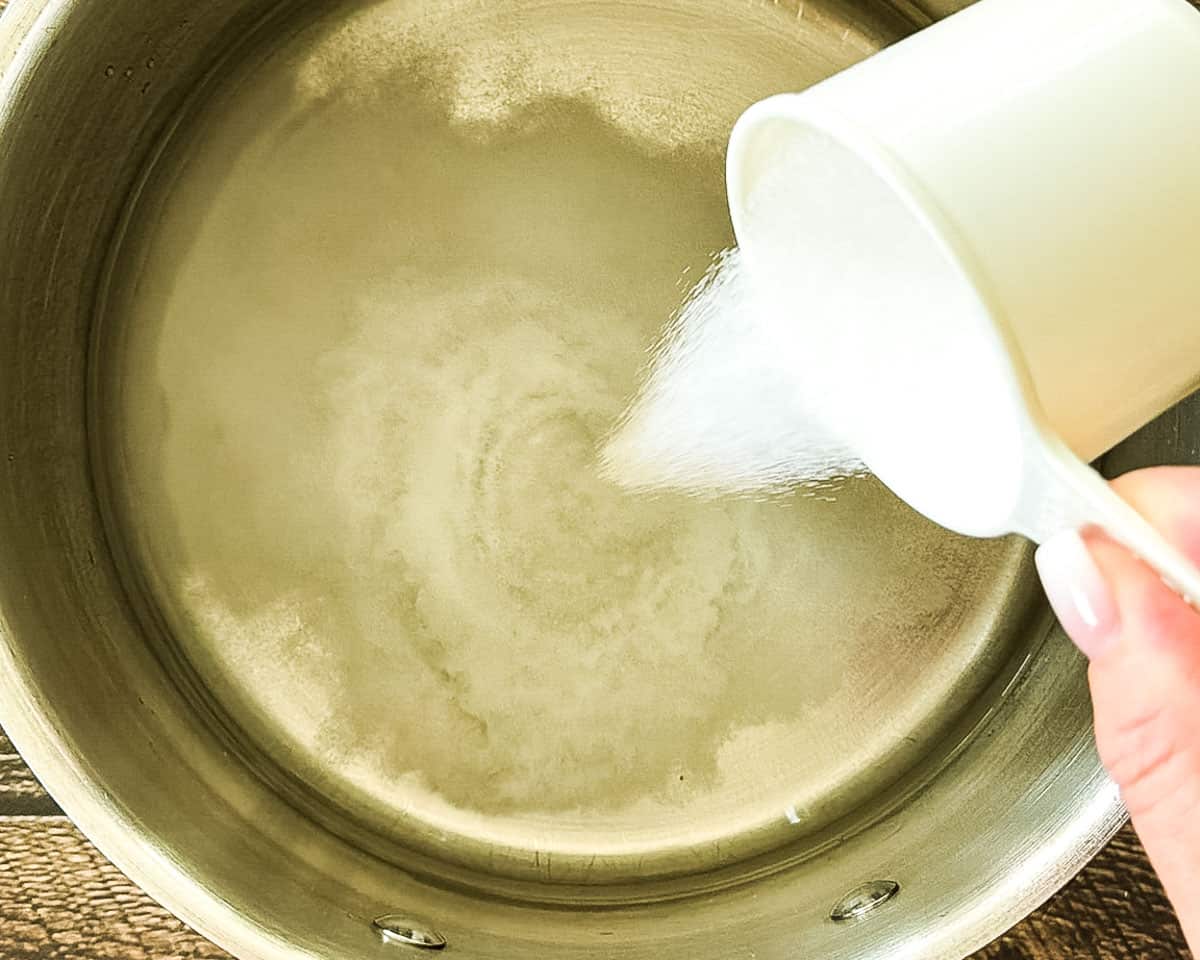 Sugar being added to water to make syrup for canned peaches.