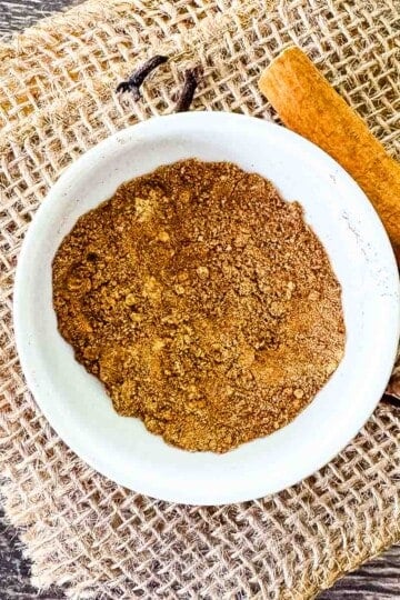 Homemade pumpkin pie spice ready to use in a small white bowl.