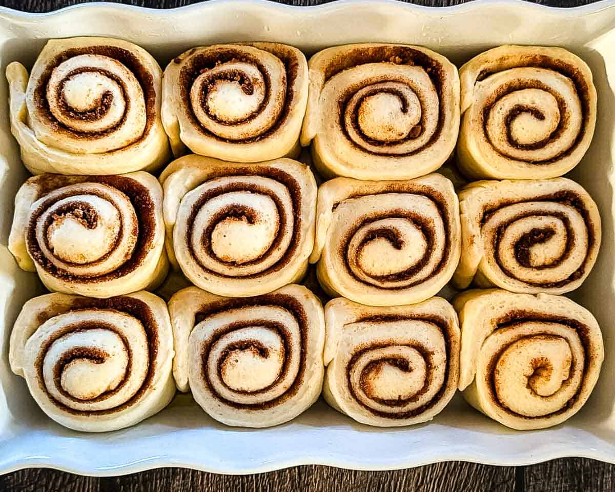 Cinnamon buns in a baking dish after the second rise.