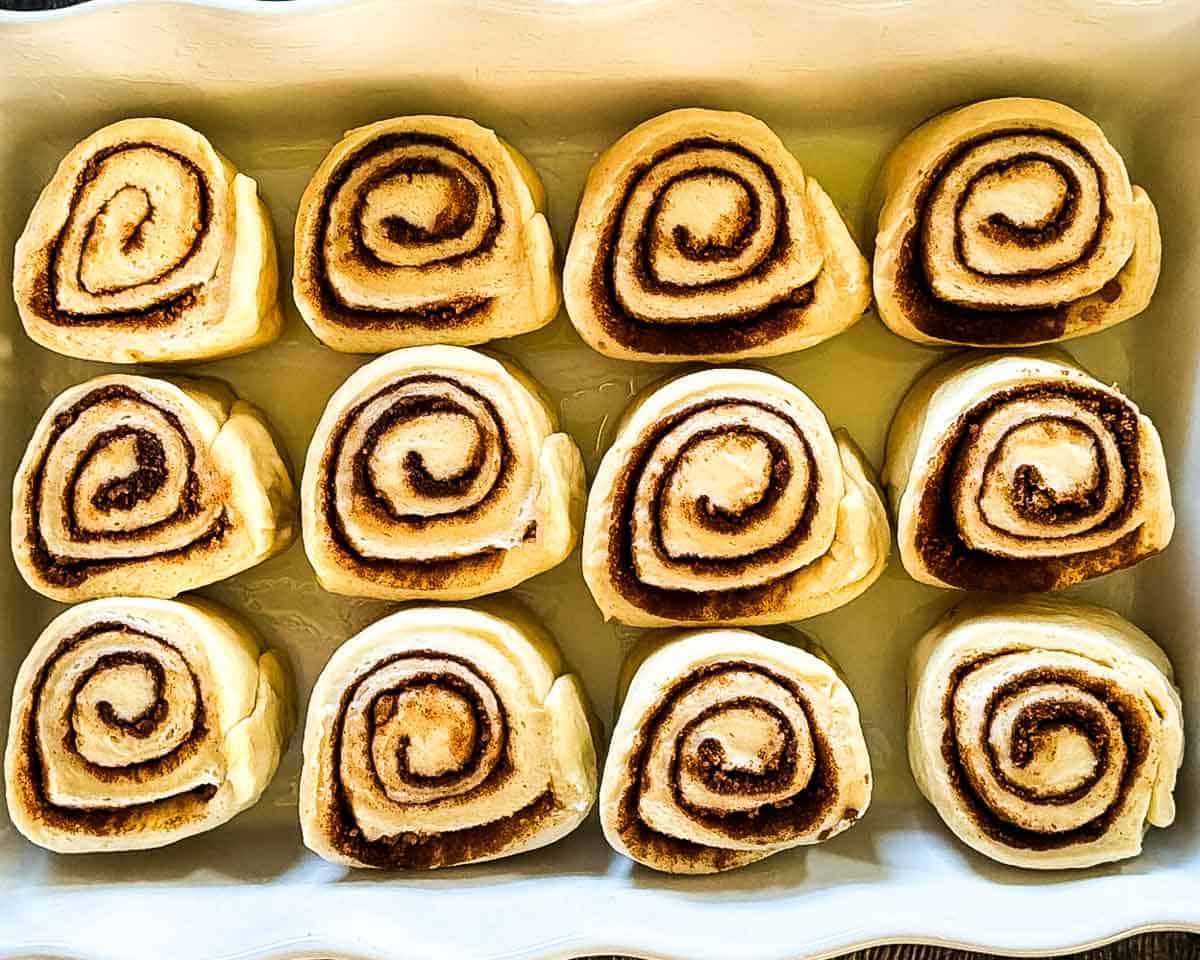 Cinnamon buns in a baking dish for the second rise.