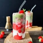 Iced strawberry matcha latte layered with strawberry puree, milk, and matcha.