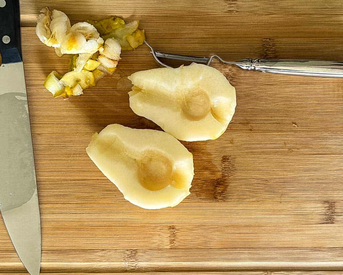 Peeled and halved pears being prepared for canning.
