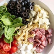 Italian pasta salad in a white serving bowl.