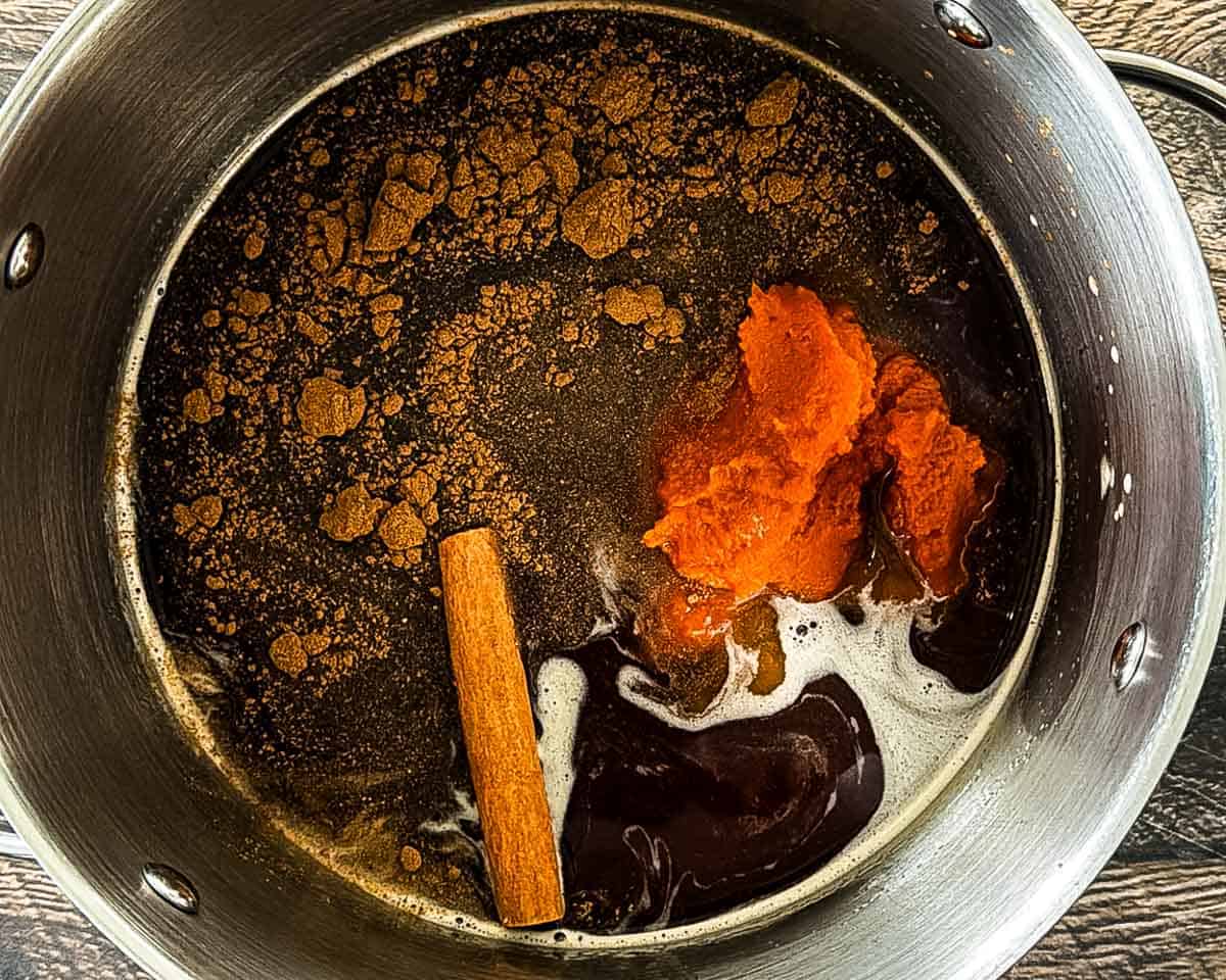 Ingredients for pumpkin spice coffee syrup in a large pot.