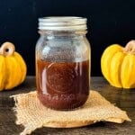 Homemade pumpkin spice coffee syrup in a glass mason jar.