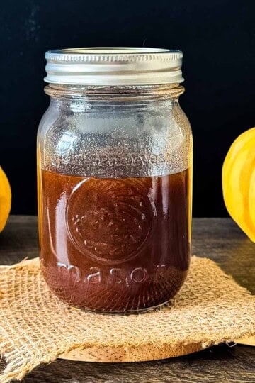 Homemade pumpkin spice coffee syrup in a glass mason jar.