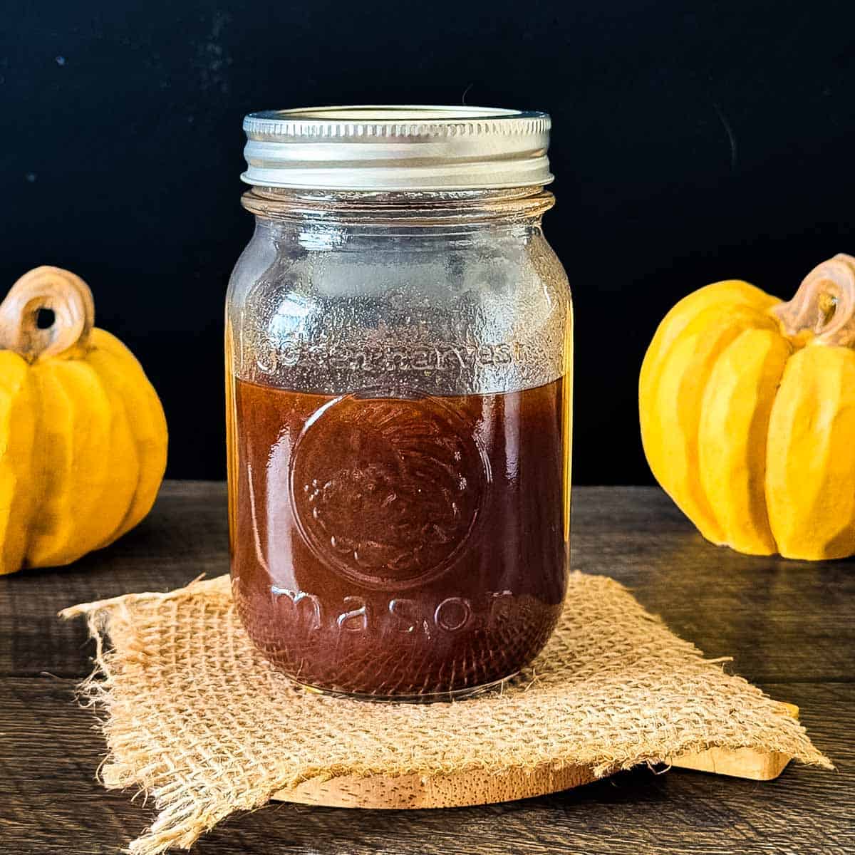 Homemade pumpkin spice coffee syrup in a glass mason jar.