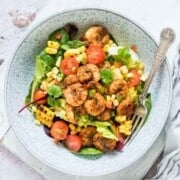 Cajun shrimp salad in a bowl with a fork.